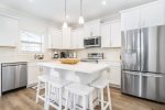 Fully equipped kitchen with stainless steel appliances and granite counters
